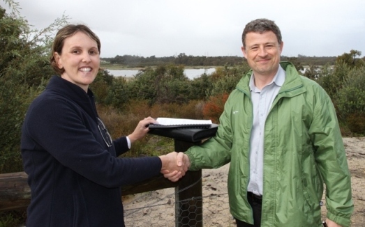 Photo of FSH Manager Offsite Coordination Chris Murray presenting the Beeliar Regional Park handover report to Renee Evans, Acting Manager Regional Parks Unit DPaW